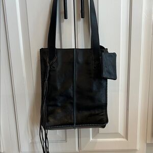 Sleek Black Leather Tote with Fringe Detail